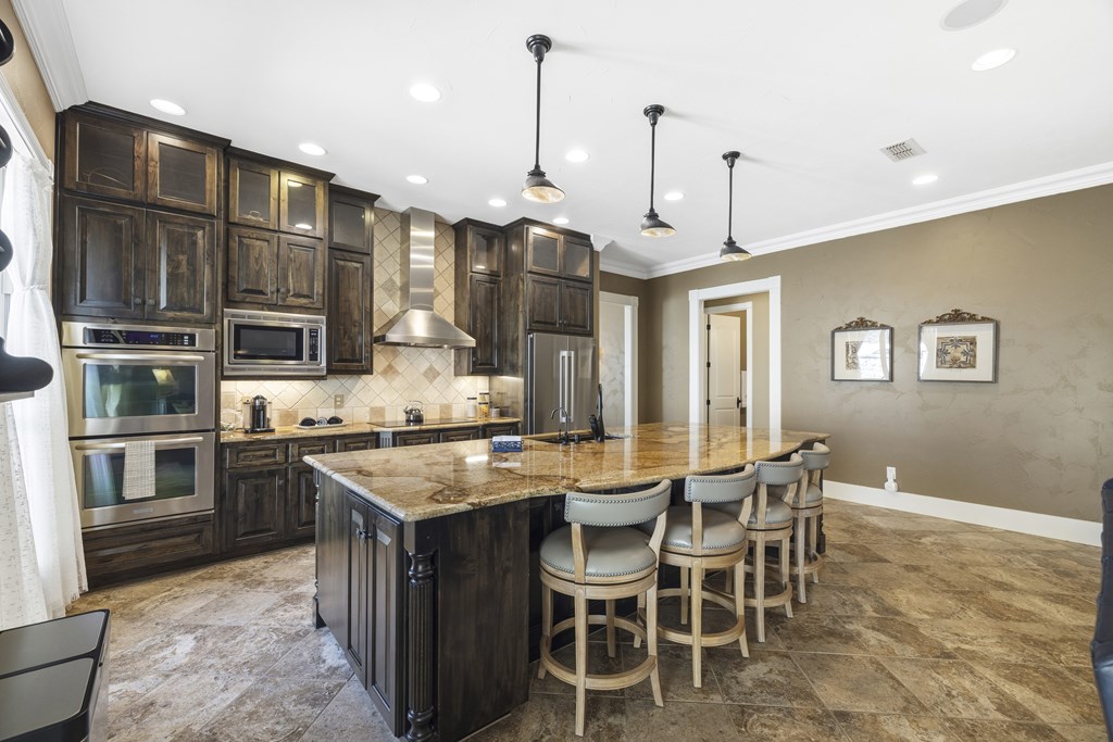 150 St Andrews Loop Kerrville, TX 78028 - Photo 9 of 27 a kitchen with stainless steel appliances granite countertop a stove and a refrigerator