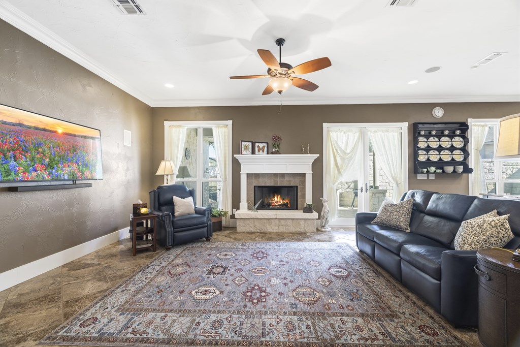 150 St Andrews Loop Kerrville, TX 78028 - Photo 10 of 27 a living room with furniture and a fireplace
