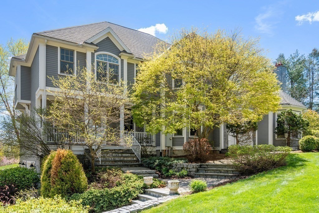 74 Carter Drive Framingham, MA 01701 - Photo 2 of 23 a front view of a house with yard and green space