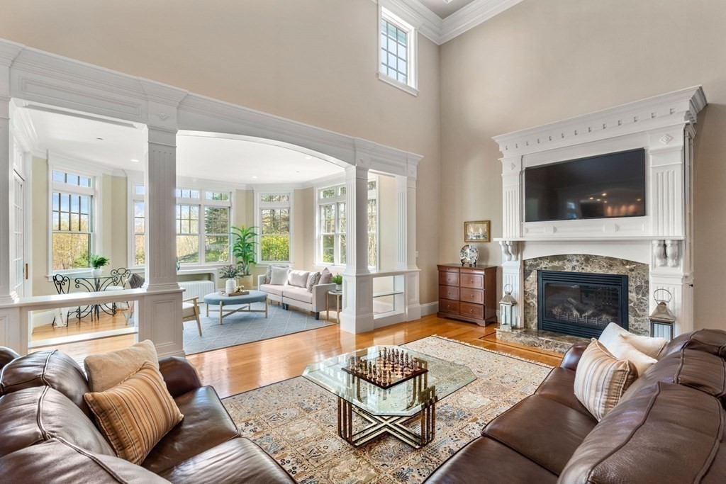 74 Carter Drive Framingham, MA 01701 - Photo 5 of 23 a living room with furniture a fireplace and a flat screen tv