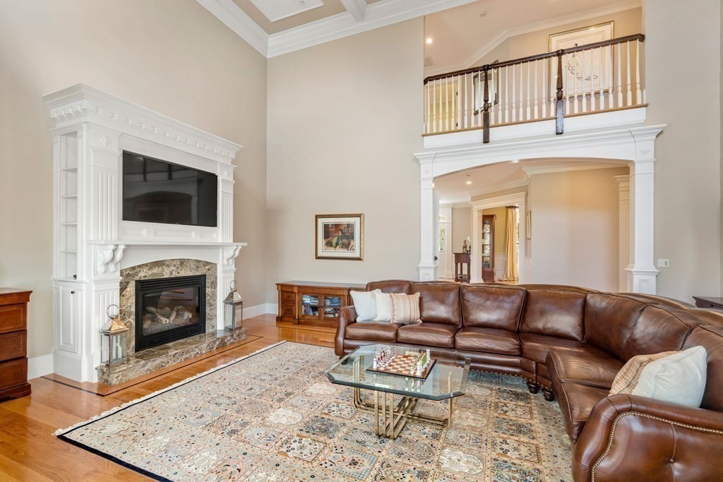 74 Carter Drive Framingham, MA 01701 - Photo 6 of 23 a living room with furniture a fireplace and a flat screen tv