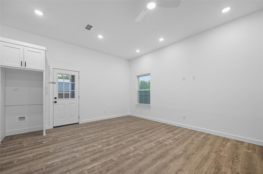 1315 Oneal Street, Unit B Commerce, TX 75428 - Photo 4 of 14 an empty room with wooden floor and window