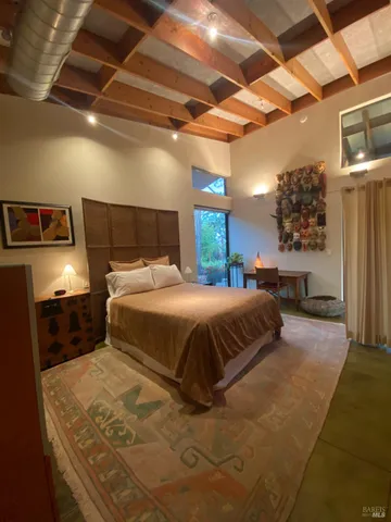 a backyard of a house with table and chairs plants and large trees