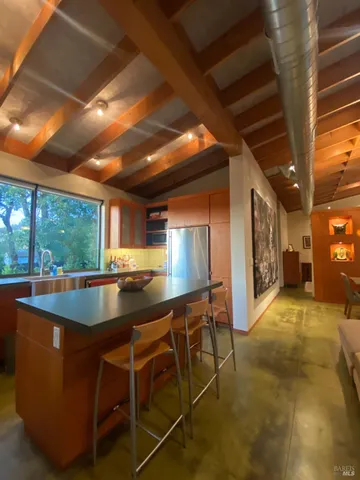 a living room with furniture and a floor to ceiling window