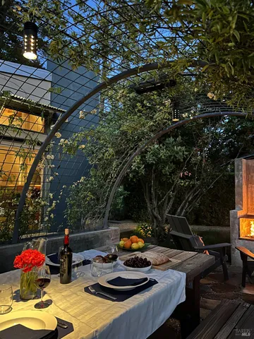 a backyard of a house with fire pit and outdoor seating
