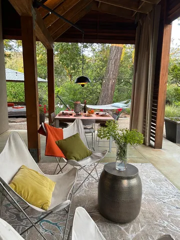 a view of a porch with chairs and backyard