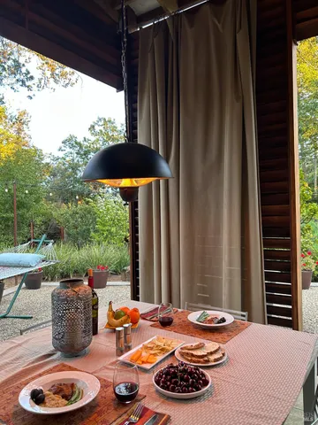 a kitchen with a stove a table and chairs