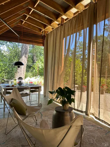 a living room with a bed and a wooden floor