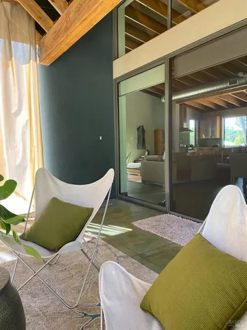 a view of a patio with table and chairs and potted plants