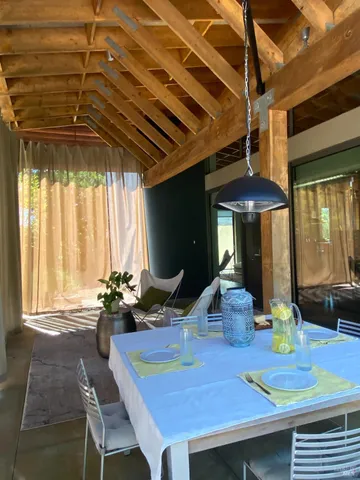 a view of a dining room with furniture window and outside view