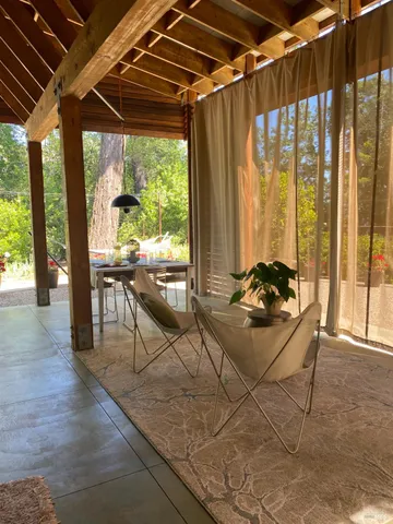 a dining room with furniture and a potted plant