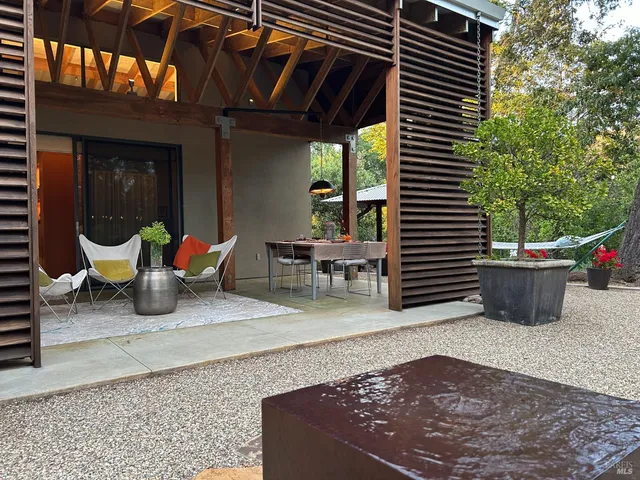 a outdoor sitting area with furniture and a potted plant