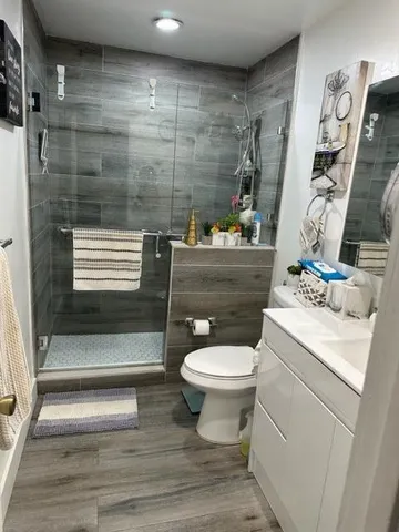 a view of a swimming pool with a patio and plants