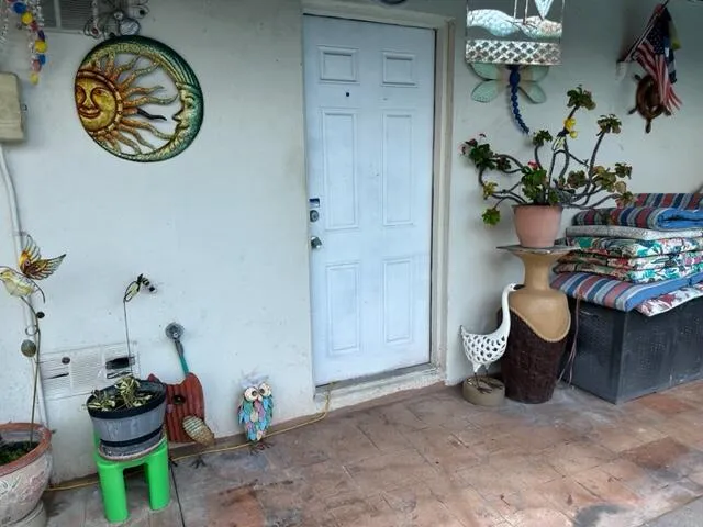 a view of a patio with a table and chairs under an umbrella