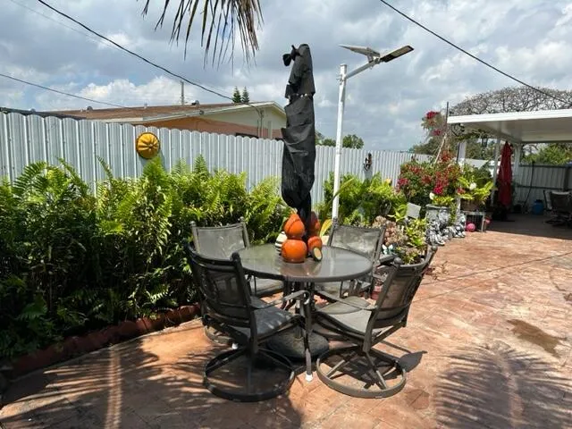 a view of a backyard with a table and chairs