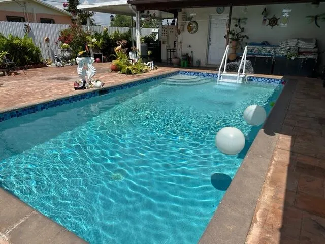 a view of a yard with plants and a bench