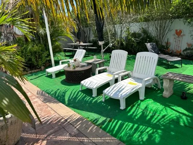 a view of a patio with table and chairs potted plants with wooden fence
