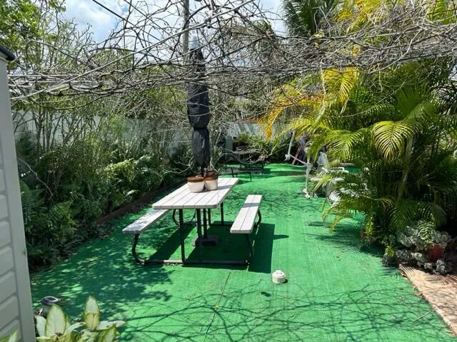 a view of a chairs and table in patio