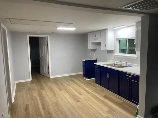a spacious bathroom with a granite countertop sink and a mirror