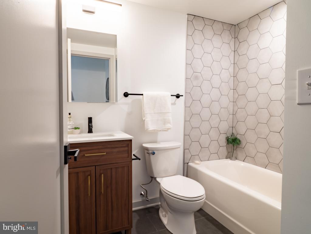 6808 Ridge Avenue, Unit 509 Philadelphia, PA 19128 - Photo 6 of 7 a bathroom with a sink a toilet and a bathtub