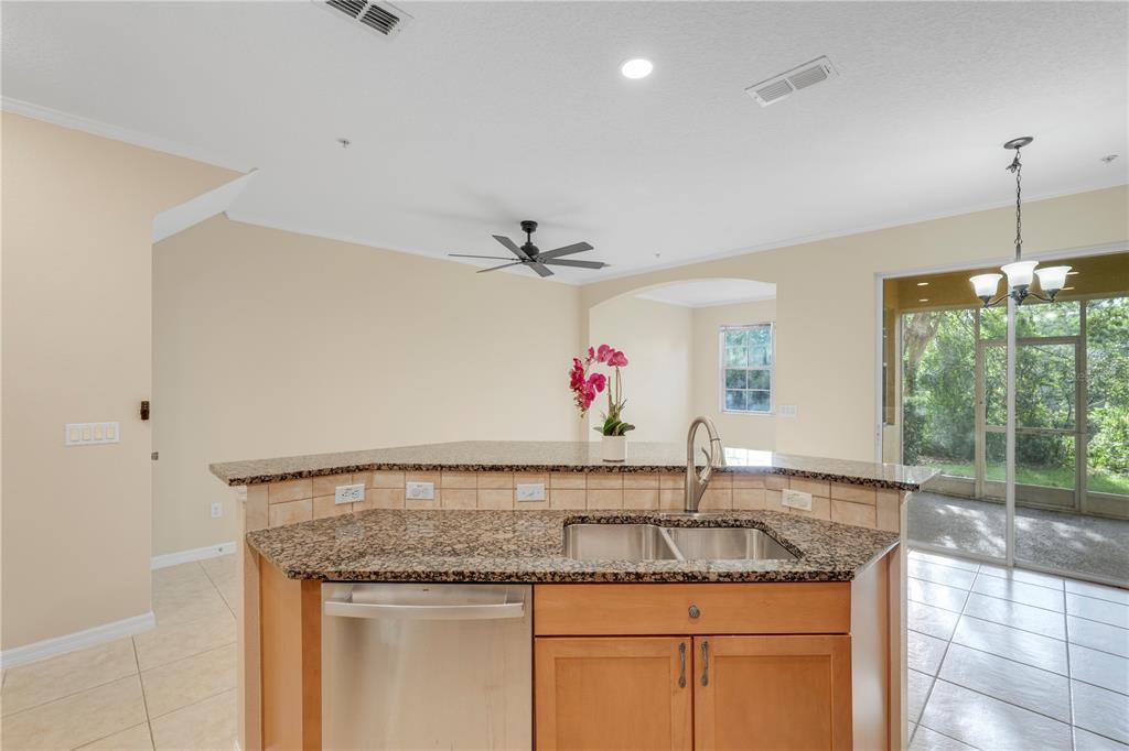 839 Assembly Court Reunion, FL 34747 - Photo 5 of 31 a kitchen with a sink and a granite counter top