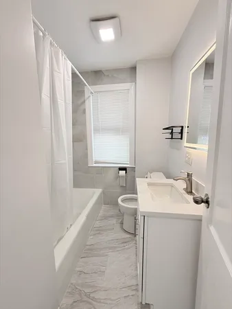 a bathroom with a sink a toilet and mirror