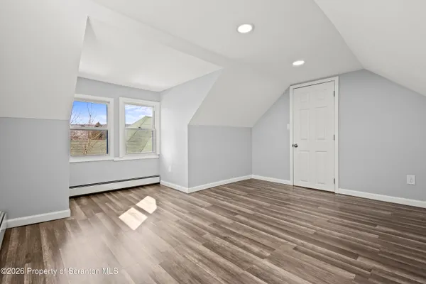 a view of an empty room with white walls