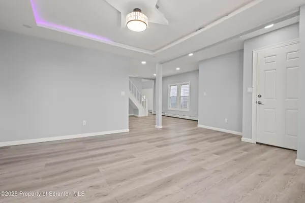 a view of an entryway with wooden floor