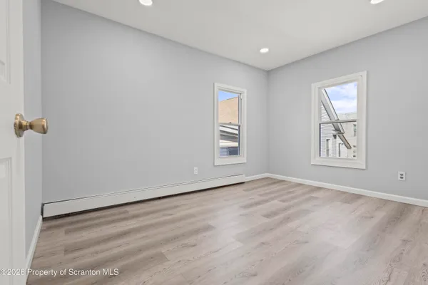 a view of kitchen with furniture and refrigerator