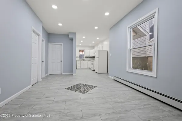 a kitchen with white cabinets stainless steel appliances and a sink