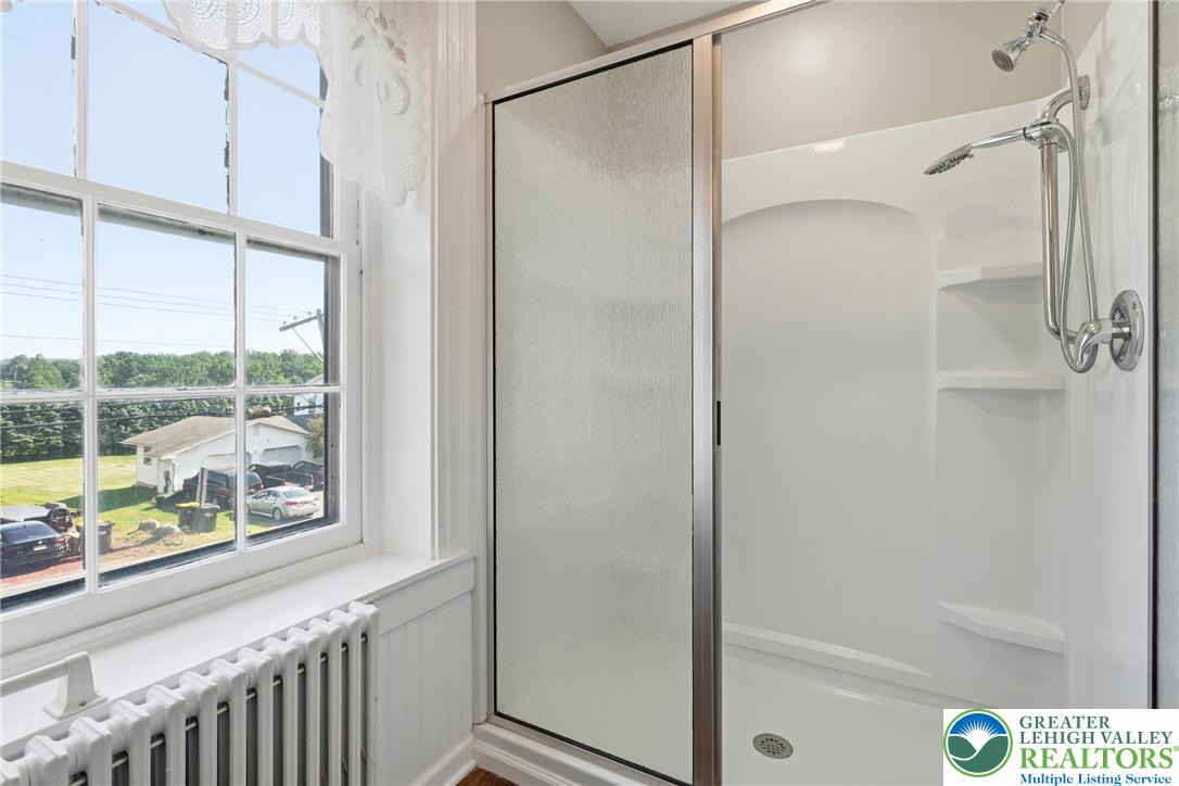4682 Steuben Road Bethlehem, PA 18020 - Photo 39 of 79 Bright shower space with an outdoor landscape view through a large window.