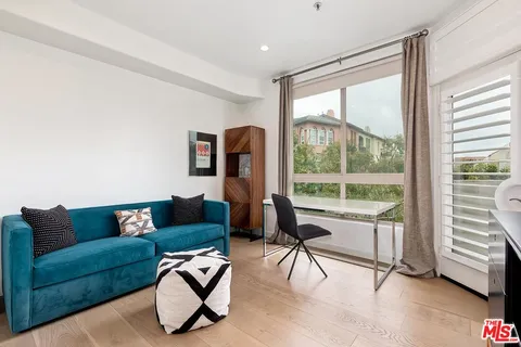 a living room with furniture and a floor to ceiling window