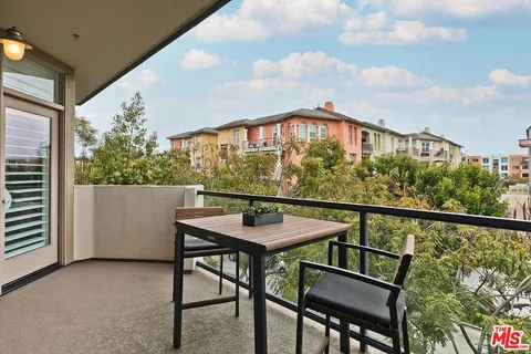 a balcony view with couple of chairs