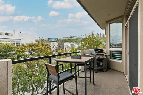 a view of a balcony with chairs