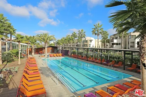 a view of a balcony with wooden floor and city view