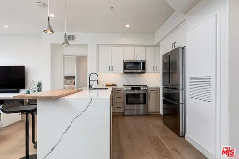a kitchen with cabinets and stainless steel appliances
