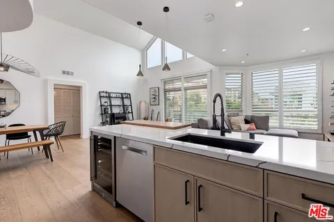 a kitchen with a sink and wooden cabinets