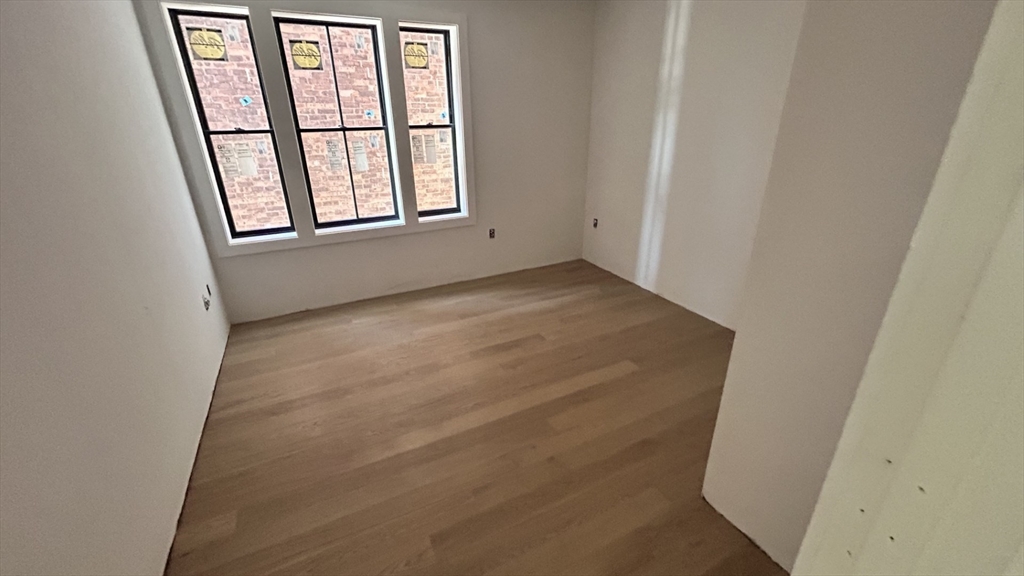 32 Orkney Road, Unit 1 Boston, MA 02135 - Photo 9 of 10 an empty room with windows