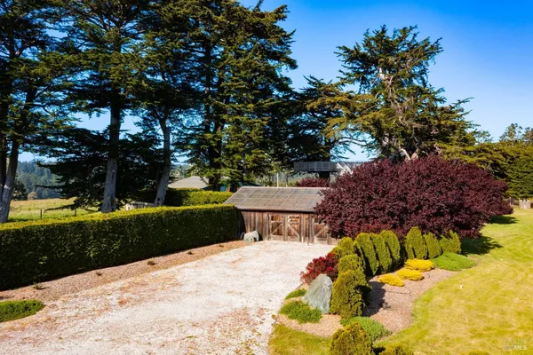 a view of a house with a backyard