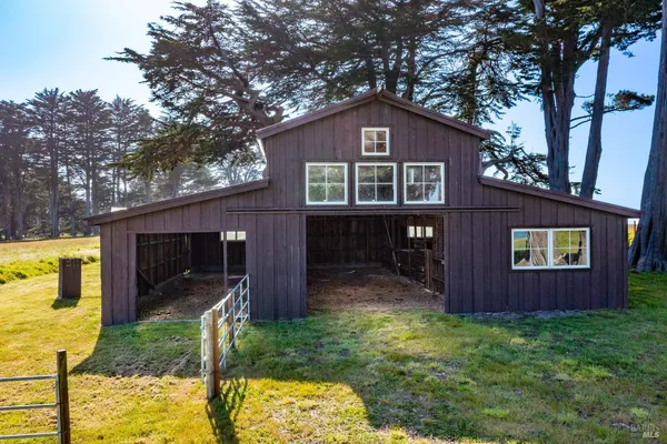 a view of a wooden house with a small yard