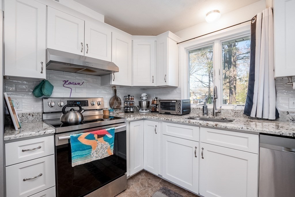 1 Roosevelt Street Wareham, MA 02571 - Photo 19 of 42 a kitchen with stainless steel appliances granite countertop a sink a stove and cabinets