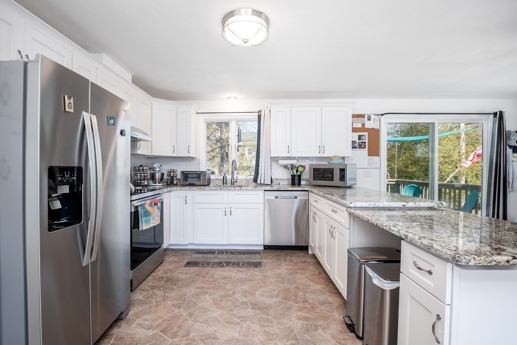 1 Roosevelt Street Wareham, MA 02571 - Photo 20 of 42 a kitchen with granite countertop a refrigerator stove top oven and sink