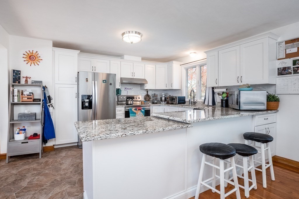 1 Roosevelt Street Wareham, MA 02571 - Photo 21 of 42 a kitchen with stainless steel appliances granite countertop a refrigerator and a stove top oven
