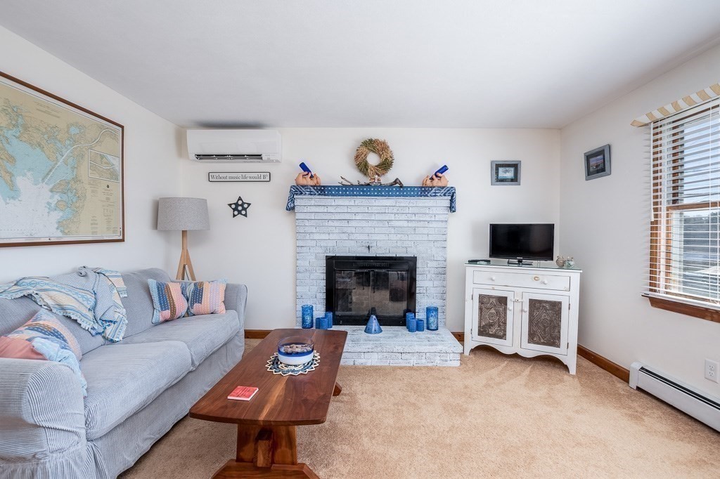 1 Roosevelt Street Wareham, MA 02571 - Photo 23 of 42 a living room with furniture and a fireplace