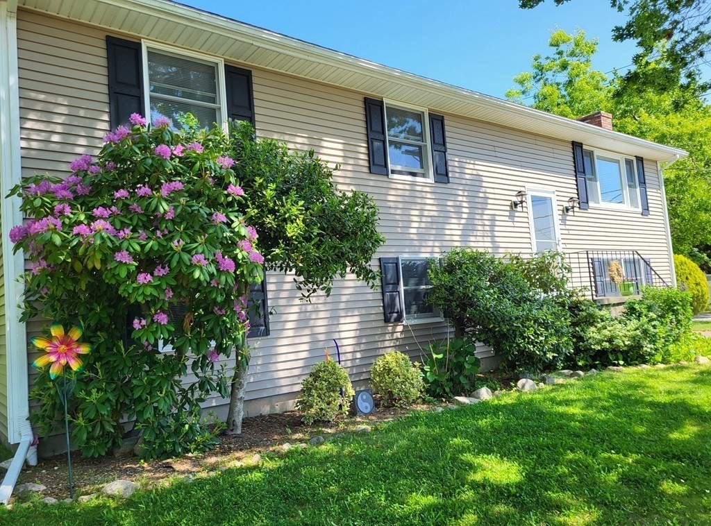 1 Roosevelt Street Wareham, MA 02571 - Photo 7 of 42 a flower garden is sitting in front of a house