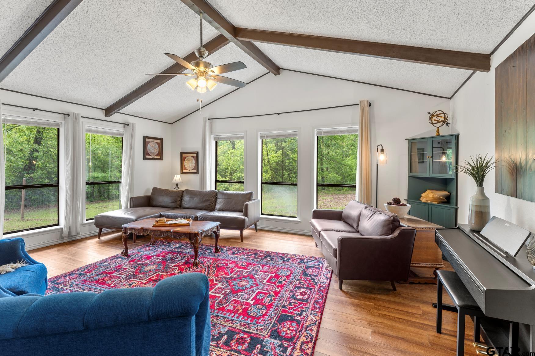 a living room with furniture and a large window