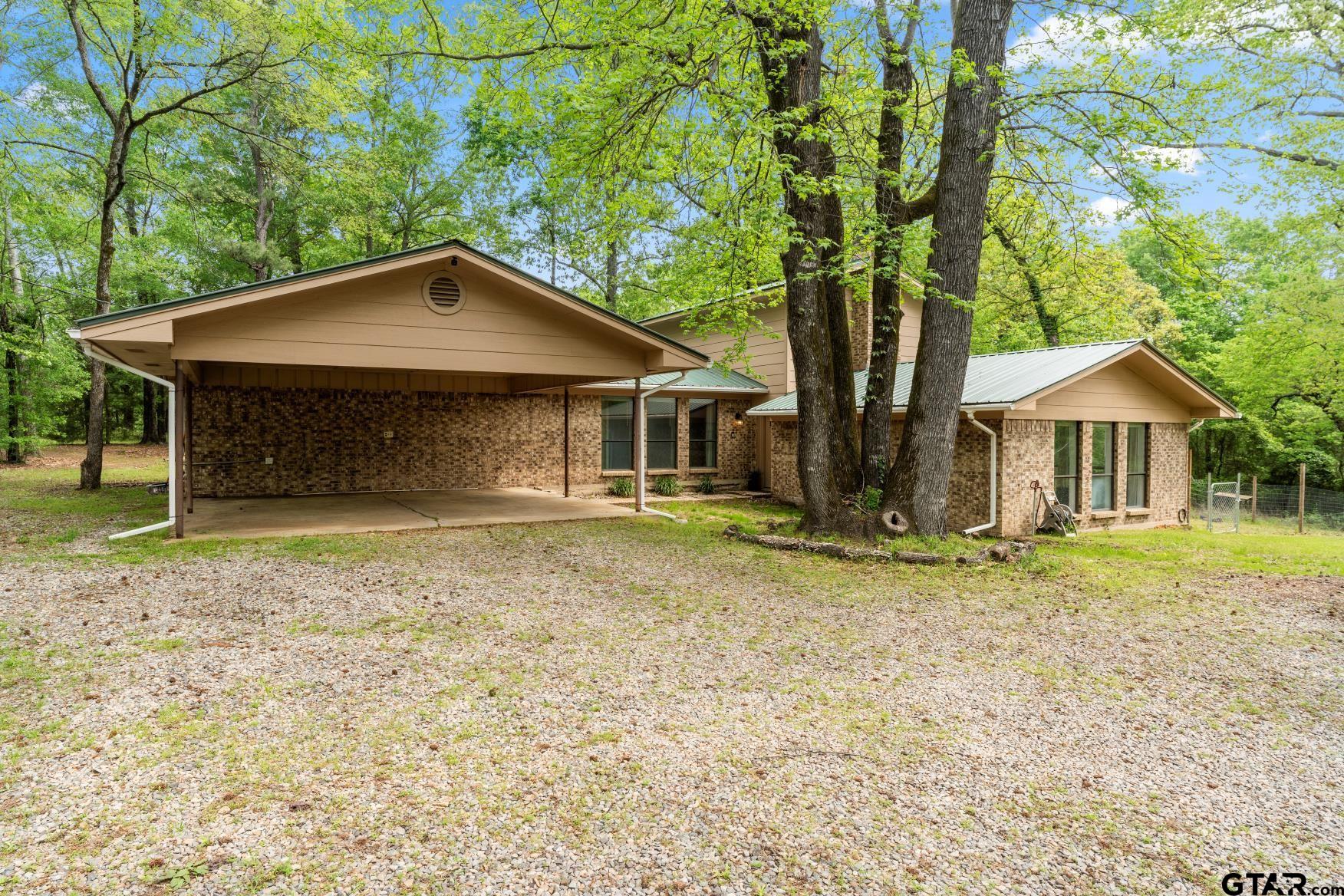 1614 County Road 2600 Mount Pleasant, TX 75455 - Photo 14 of 27 a front view of a house with a garden