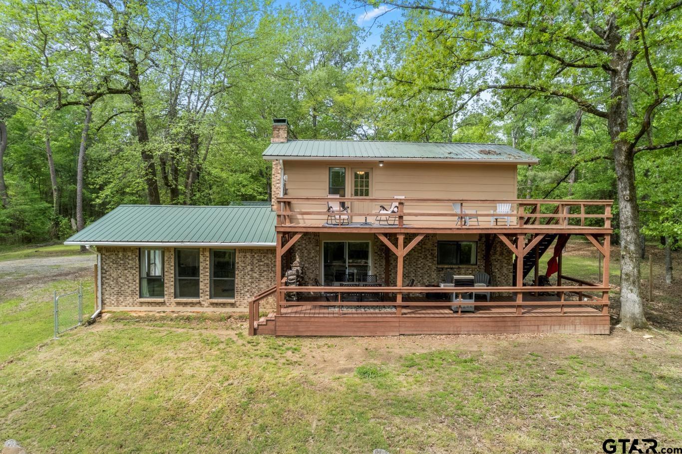 1614 County Road 2600 Mount Pleasant, TX 75455 - Photo 18 of 27 a view of a house with pool table and chairs under an umbrella
