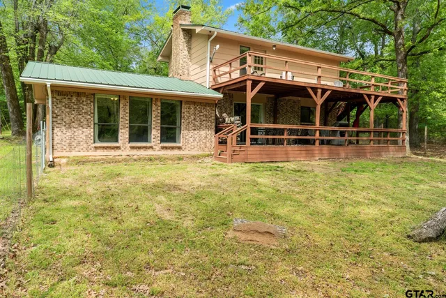 a view of a house with backyard porch and sitting area