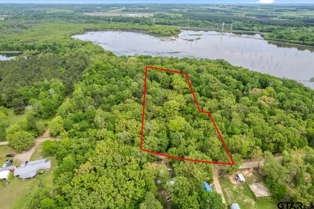 an aerial view of a houses with a yard